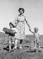 A young family of 5 walking with food supplies