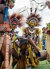 Papuan men with drums wearing traditional clothing