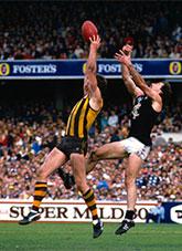 2 football players making a jumping for a mark.