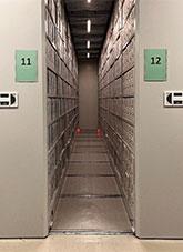 Beige compactus with archival file boxes on shelves
