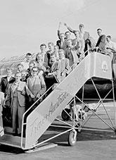 German migrants arrive aboard a VISCOUNT delivery flight. A group of twenty young German migrants arriving at Essendon airport, Melbourne, on the new Viscount turbo-jet airliner of T A A called CHARLES STURT. The migrants flew from Hamburg, Germany, under the assisted passage scheme sponsored by the Inter-governmental Commitee for European Migration