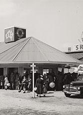 A crowd gather around a small ABC studio building