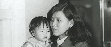 A Vietnamese woman holding a child