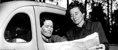 Sisters Graves and Fawcett of the New South Wales Far West Children's Health Scheme study a map. 
