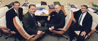 The Howard Government Cabinet seated around a table in the Cabinet Room. 