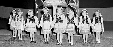 Migrant children in national costume.