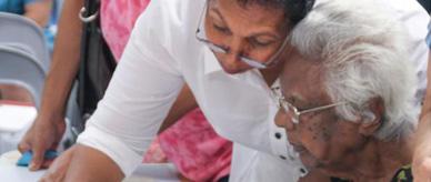 Phyllis Williams showing her mother the Larrakia petition. 