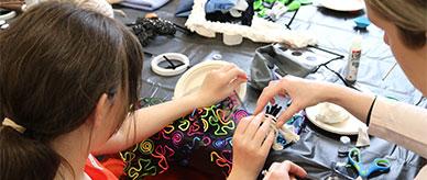 A young blind child making art.