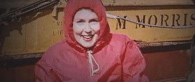 Nelle Law smiling and dressed in a red waterproof jacket. 