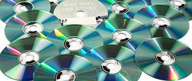 An arrangemet of compact discs showing the reflective read side.
