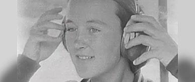 An athelete removing ear muffs