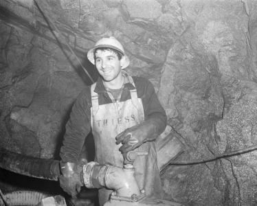 Photograph of Romolo Fubelli at work as a tunnel pump attendant, 1960.