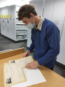 Nicholas Hams examining some Maltese migration records in the North Melbourne Research Centre. 
