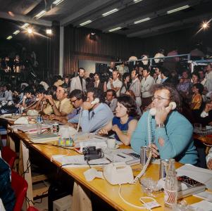 A tally room with people making telephone calls.