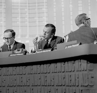 3 journalists seated at an ABC News desk.