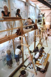 Electoral staff working on the 2-story high tally board with elevated walkway.
