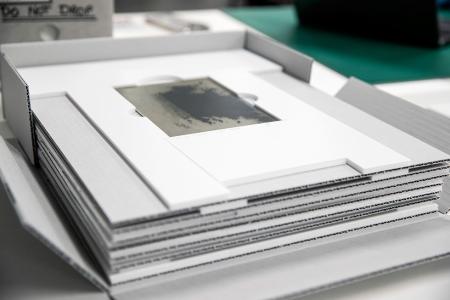 Glass negative held within a cardboard frame.