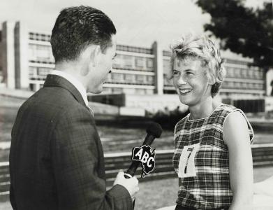 A female athlete being interviewed by a male journalist