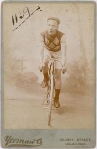 Studio portrait of William Nean on his racing bike.