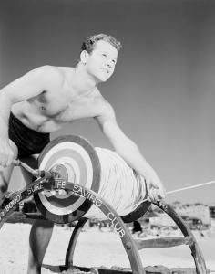 A surf lifesaver operates the reel.