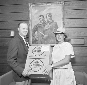2 people holding 2 boxes of Akubra hats