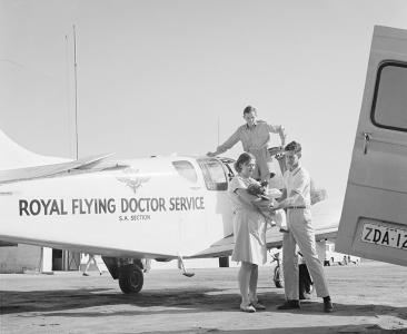 Aboriginal baby being transfered from a Flying Doctor plane to an ambulance, 1966
