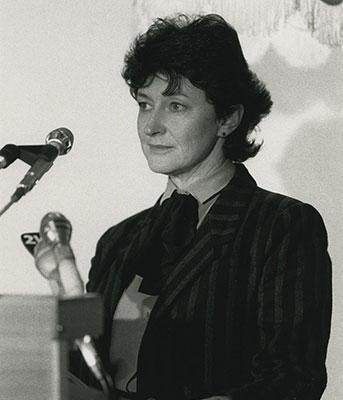 Susan Ryan standing behind a lectern.