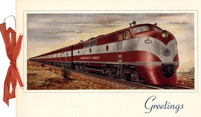 Colour print of a red train with white stripe in the desert..
