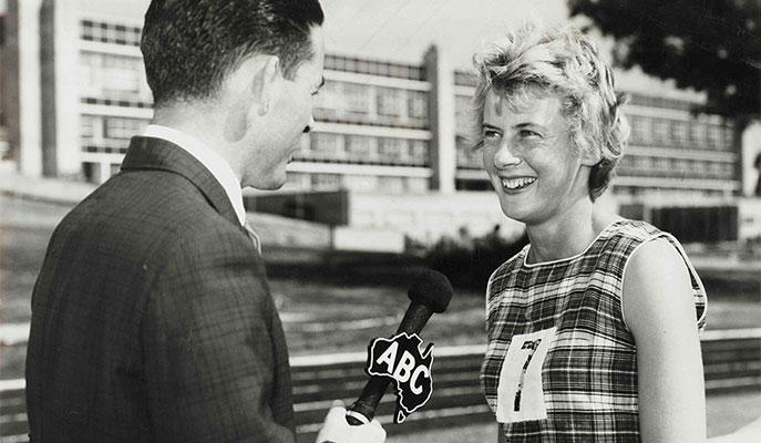 A female athlete being interviewed by a male journalist