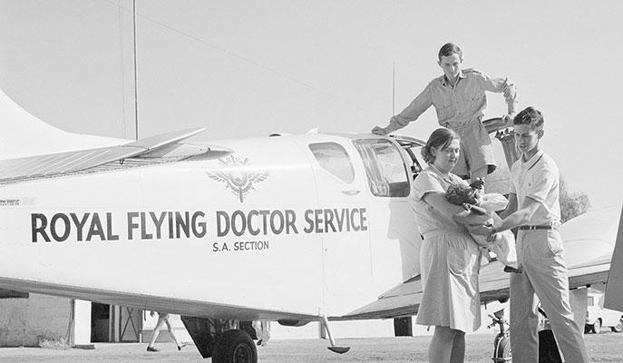 Aboriginal baby being transfered from a Flying Doctor plane to an ambulance, 1966